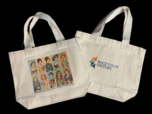 Two tote bags, one with a vintage-style illustration and the other with 'Rocktown History' branding, on a dark background.